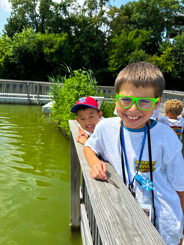 Summer camp friends smiling together on an outdoor field trip